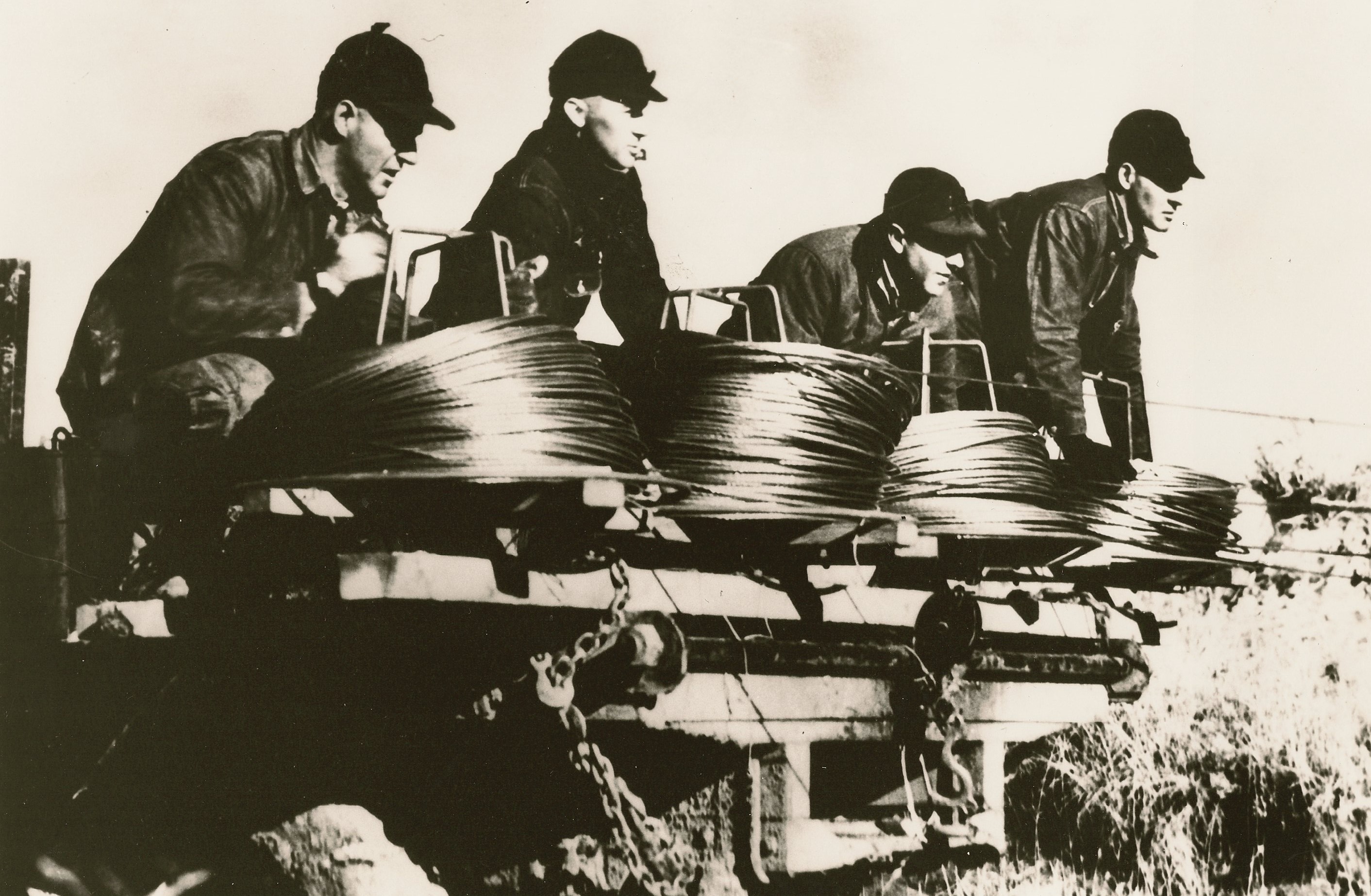 This photo, titled “the Four Horsemen of the Lines,” is a famous photo in rural electrification. Four farmers from Kansas, in Brown-Atchison Electric Cooperative Association’s service territory, are pictured taking part in stringing the last miles of wire before the system was energized. Source: “The Next Greatest Thing,” published by NRECA