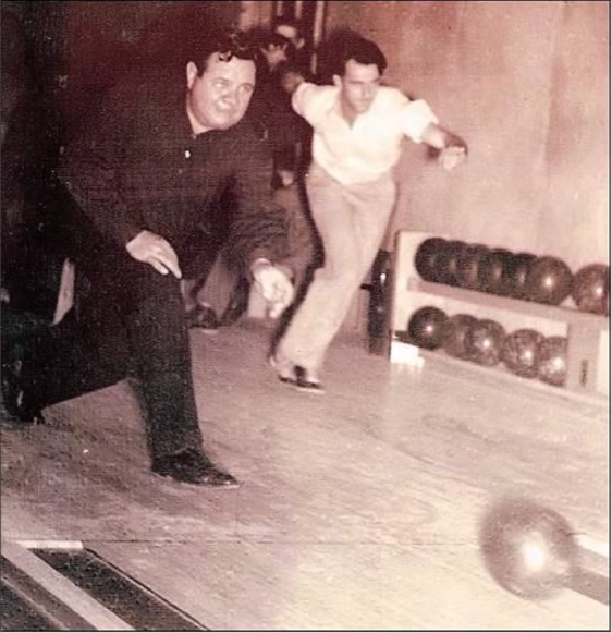 Black-and-white photo of Babe Ruth bowling with a young Jim Henderson, who would go on to become a member of Sussex Rural Electric Cooperative’s Board of Directors
