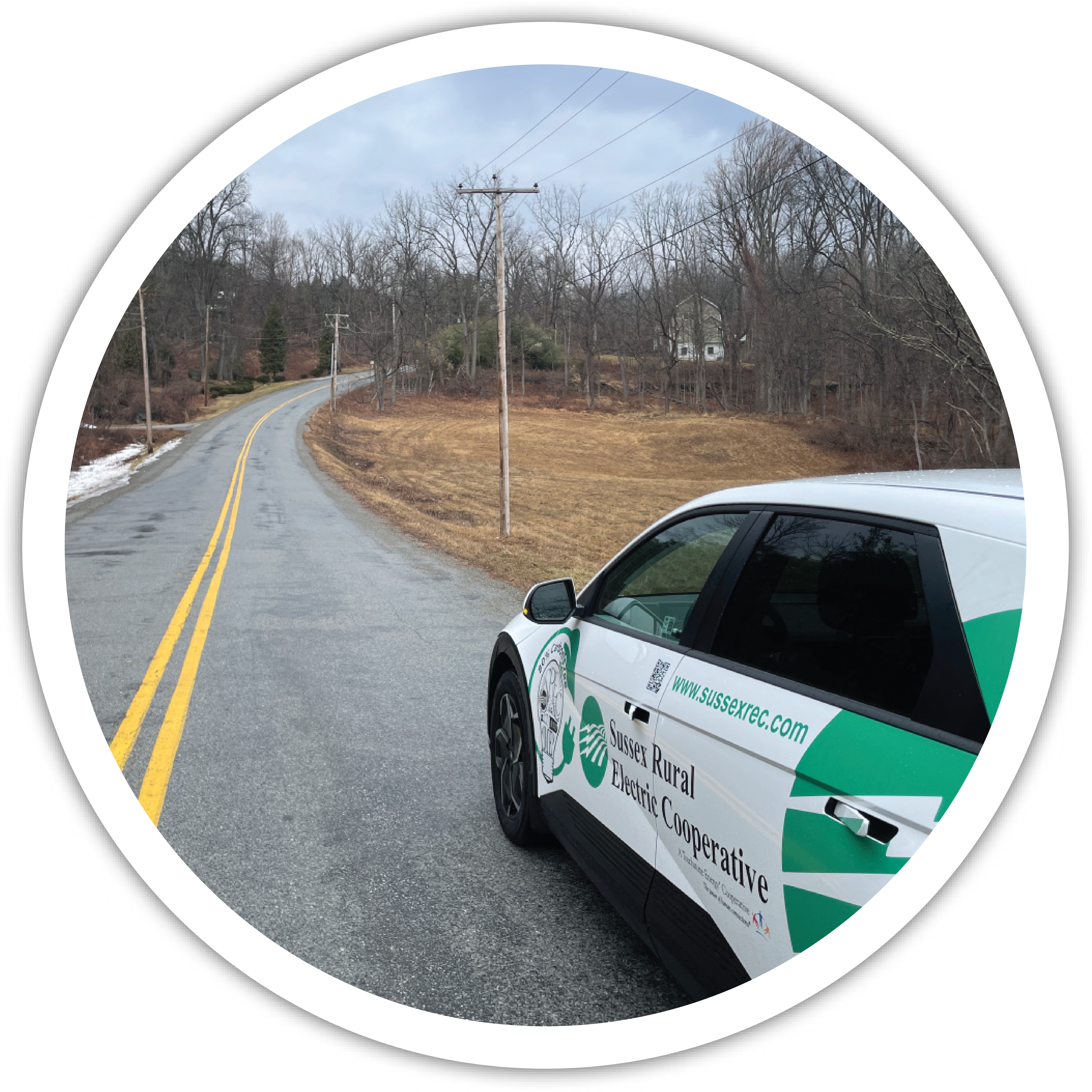Pictured: Sussex Rural Electric Cooperative's 2024 Hyundai Ioniq parked on the roadside facing a Sussex REC utility pole.