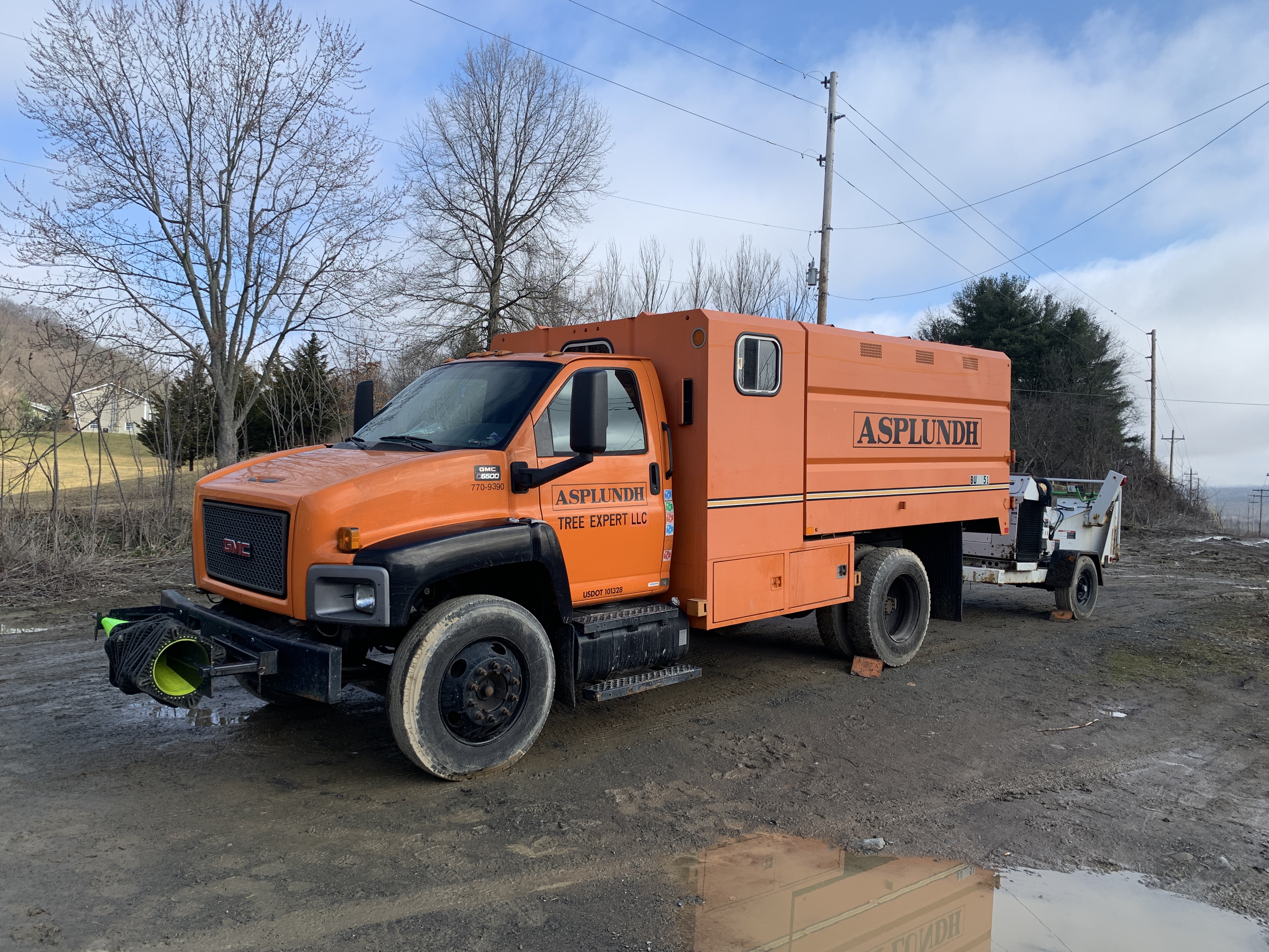 Photo of one of the orange trucks of SREC's current tree contractor, Asplundh Tree Experts LLC.