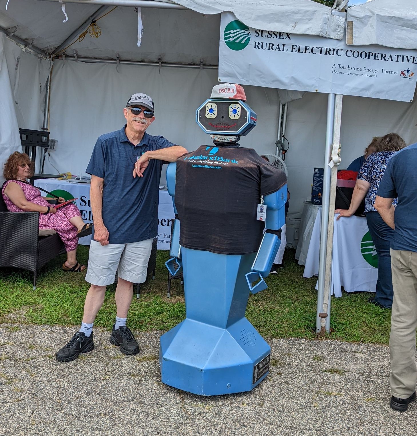 Chairman of SREC's Board of Directors, Jack Haggery, poses with Oscar the Robot at the Sussex County Fairgrounds