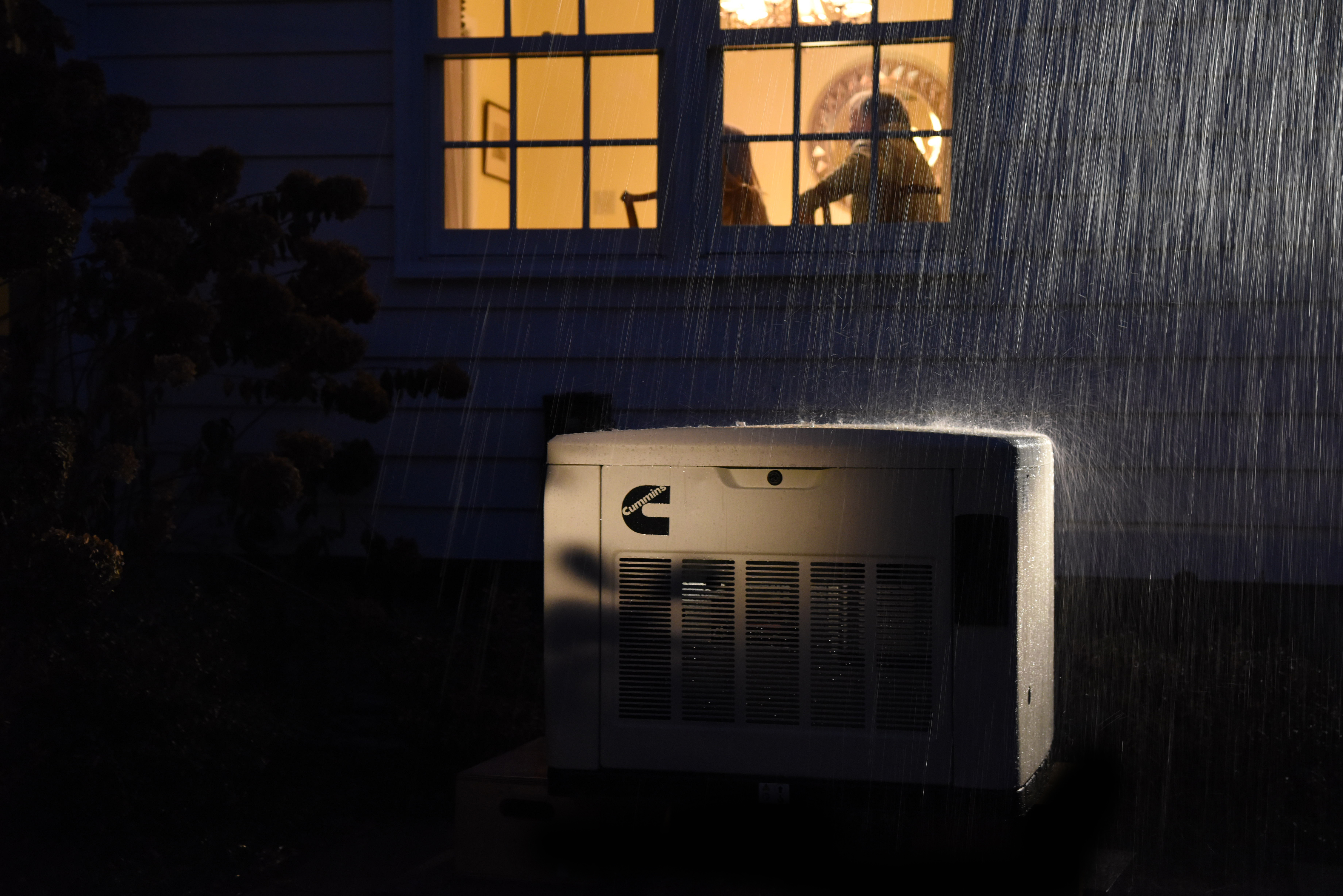 A Cummins Quiet Connect Standby Generator powering a home during a storm