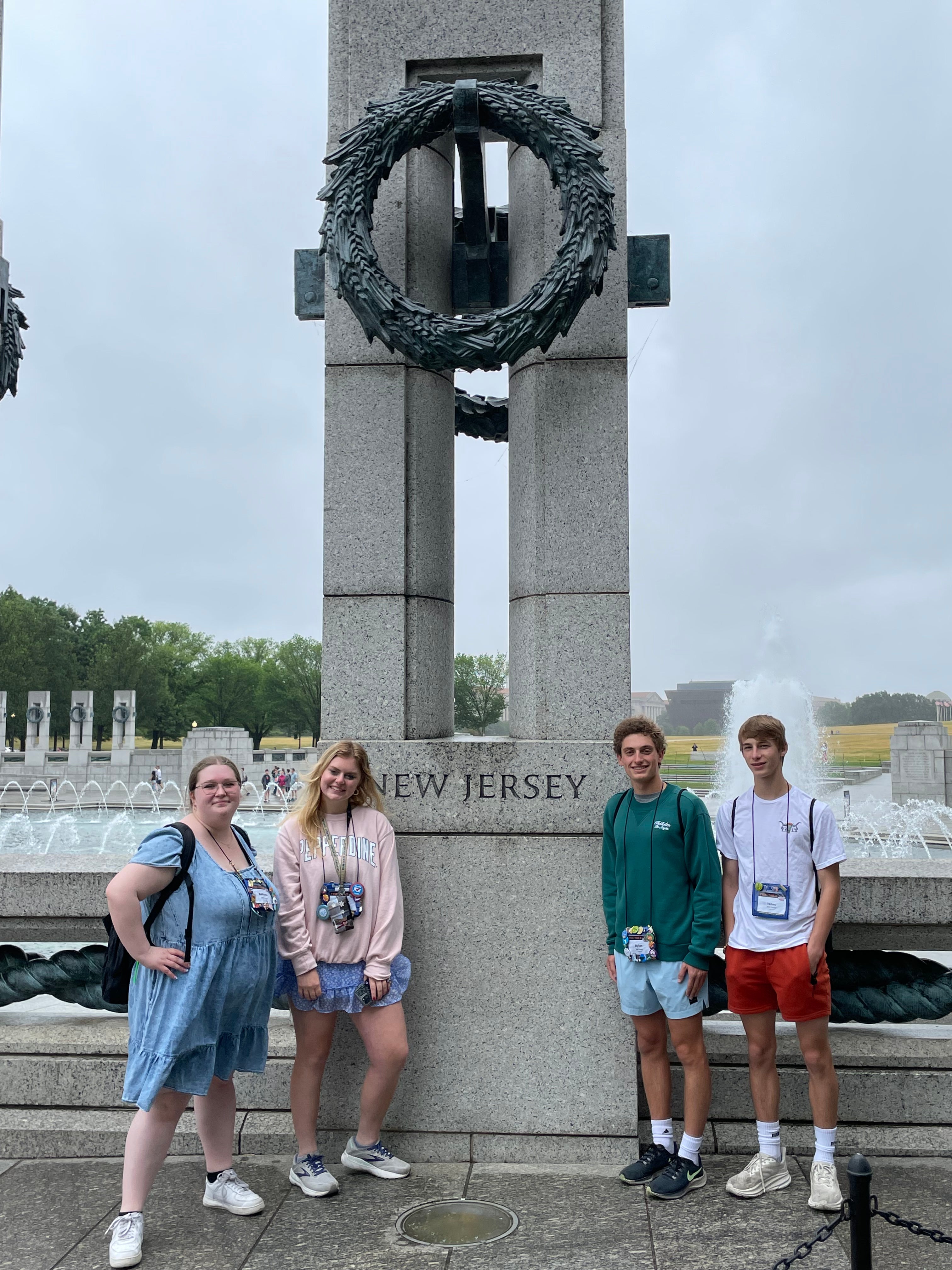 2023 New Jersey Youth Tour students (from left to right: Bethann Juhr, Maddie Kappelmeier, Dylan Barca, and Isaac Schuman) post at the New Jersey monument at the World War II Memorial in Washington, D.C.