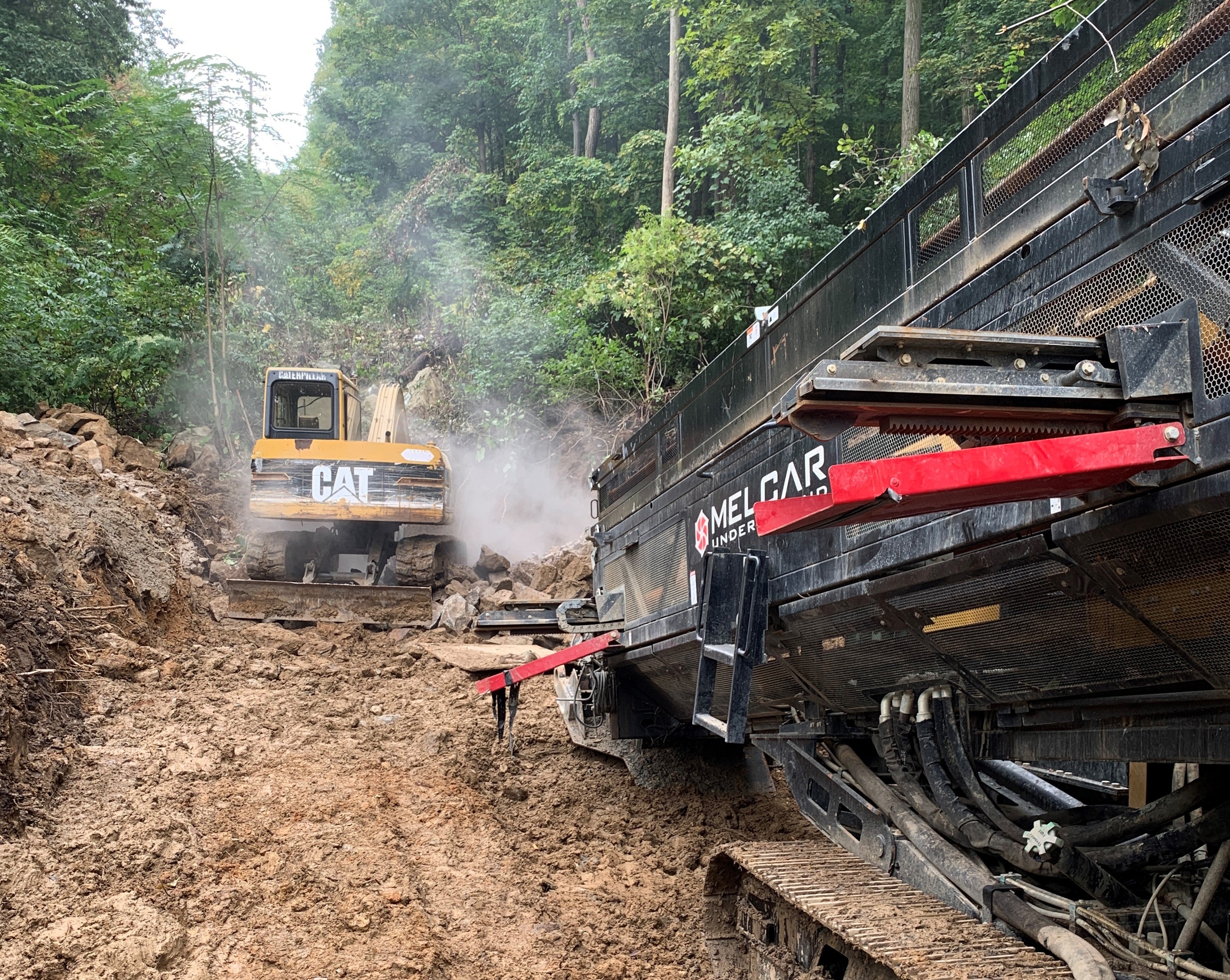 A large boring machine drills a hole into the rocky ground in order for SREC to install underground power lines