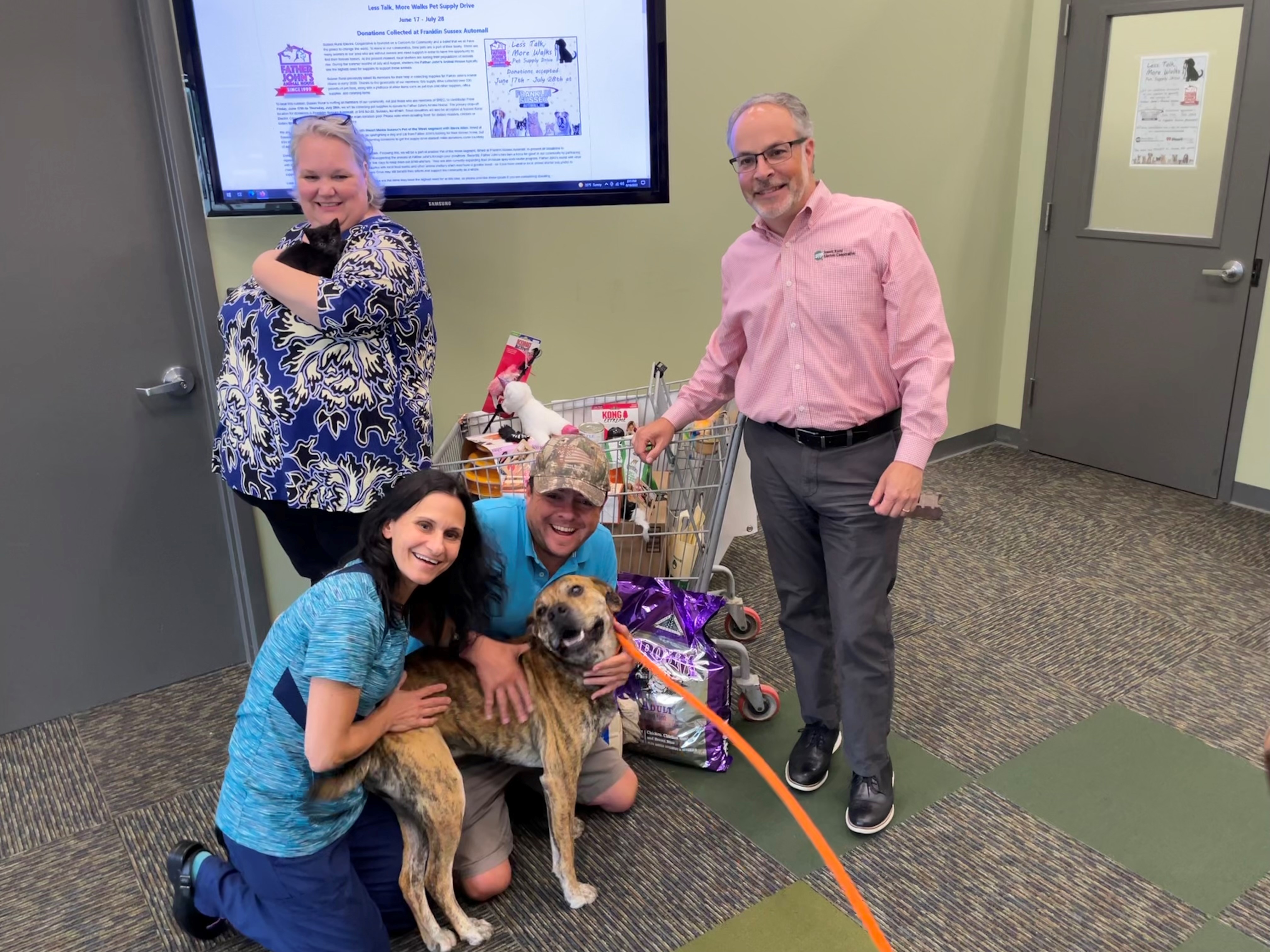 Photo of SREC staff, Steve Allan from 102.3 WSUS, and Dr. Karen Bullock posing with Sassy the kitten and Spanky the dog (both from Father John's Animal House) as part of a 6/16/22 Pet of the Week segment